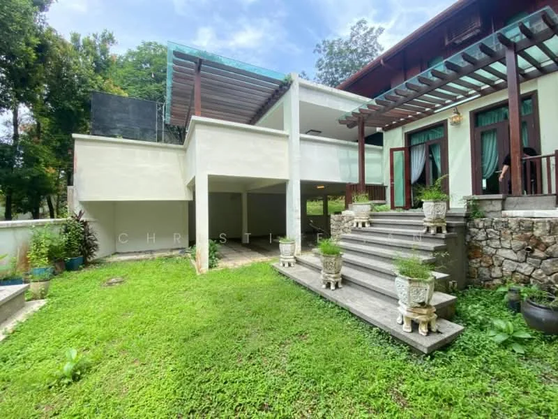 Exterior type: detached bungalow; features: two-storey structure, stone cladding on lower level, white painted facade, pergola over outdoor area, manicured lawn, garden area with potted plants, balcony with railing, steps leading to entrance, surrounded by greenery, large windows, outdoor space with seating area; style: modern.
