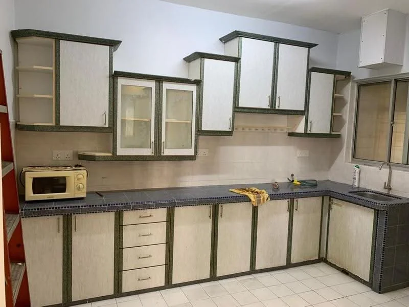 Kitchen features: laminate cabinetry with green trim, grey countertop, single-bowl stainless-steel sink, chrome faucet, built-in microwave, glass-front upper cabinets, open shelving, tile backsplash, white tiled flooring, window with metal frame, kitchen towel on countertop.