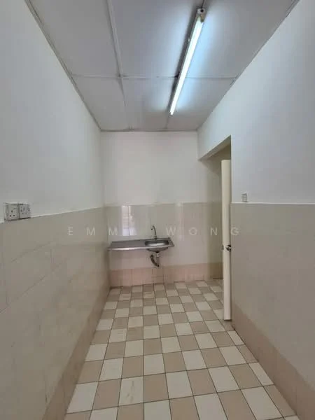 Laundry features: white painted walls, cream tiled backsplash, light grey floor tiles, single-bowl stainless-steel sink, wall-mounted faucet, fluorescent ceiling light, door leading to another room.