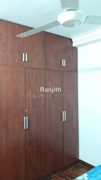 Room features: wooden wardrobe with multiple doors, ceiling fan, wooden flooring, white painted walls, decorative ceiling moulding.