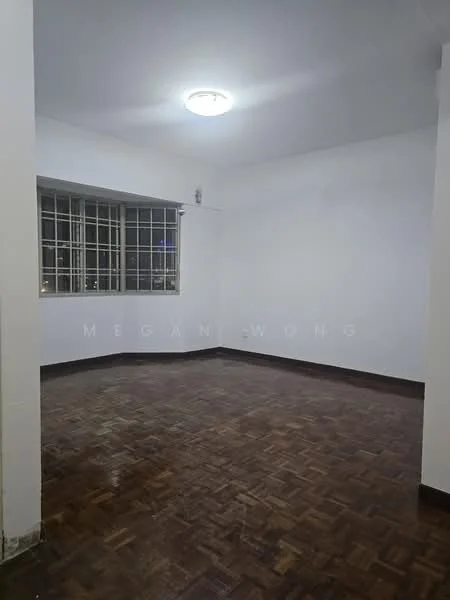 Room features: white painted walls, parquet wood flooring, ceiling light fixture, large window with metal grille, corner window, neutral decor, empty space.