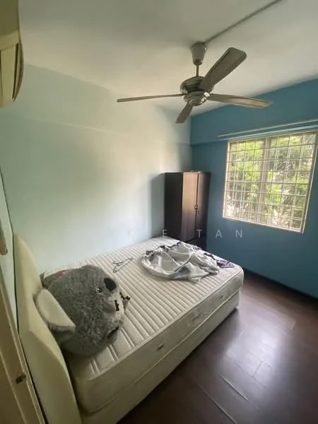 Bedroom features: light blue painted walls, dark wood flooring, 5-blade ceiling fan, window with view of greenery, queen-size bed with no bedding, black wardrobe, decorative koala plush toy; view: garden.