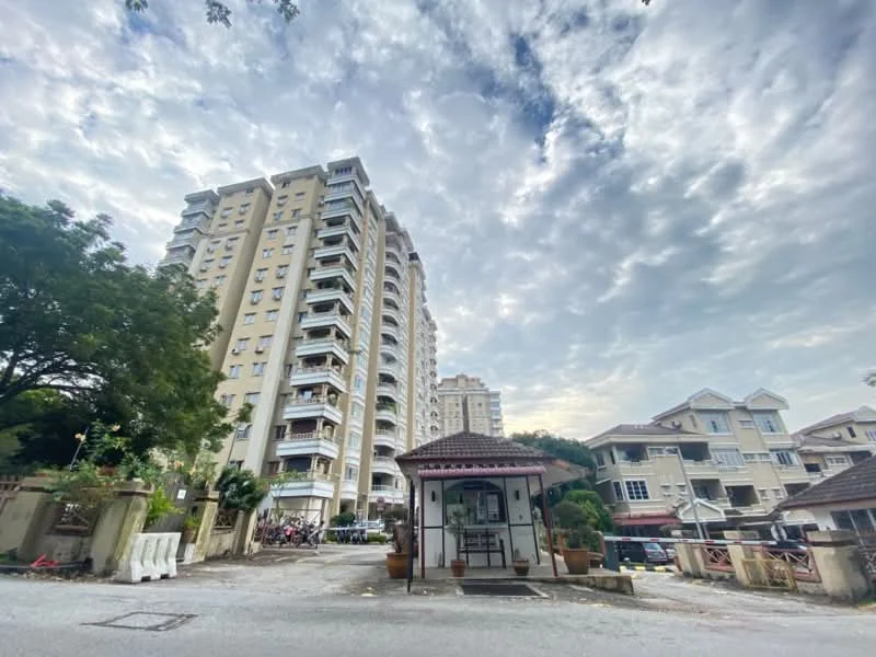 Exterior type: mid-rise condominium; features: multiple-storey building, balconies on upper floors, entrance gate with guard house, surrounded by greenery, paved driveway, residential area, cloudy sky, landscaped garden area; style: modern.