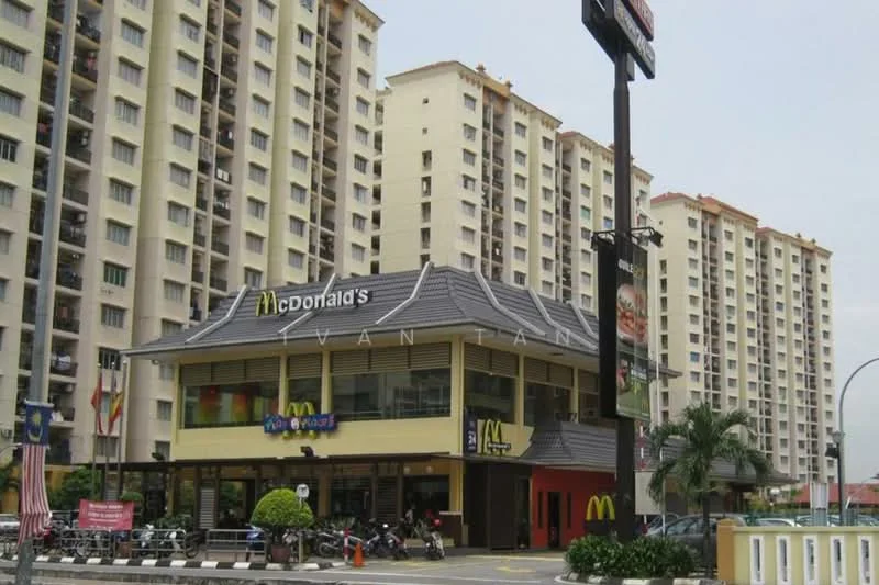 Exterior type: low-rise apartment block; features: multiple-storey building, balconies visible on upper floors, commercial building at ground level, signage for McDonald's, parking area in front, manicured landscaping, paved walkway, street lighting, surrounding palm trees; style: modern.