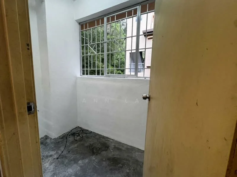 Room features: white painted walls, concrete flooring, window with metal grille, exposed electrical wiring, natural light from window; view: garden.