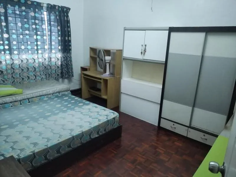 Bedroom features: queen-size bed with patterned bedding, wooden flooring, window with blue and white polka dot curtains, built-in wardrobe with sliding doors, wooden study table, table fan, decorative wall shelf, green accent wall; style: modern.