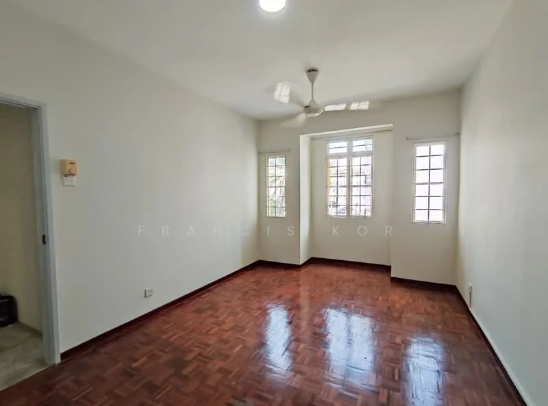 Room features: white painted walls, parquet wood flooring, 5-blade ceiling fan, two small windows with grid pattern, one larger window with grid pattern, natural light from windows, light fixture on ceiling; style: minimalist.