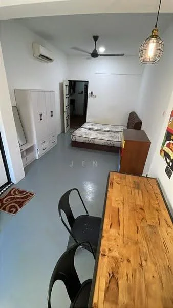 Room features: light blue flooring, white painted walls, 1 wall-mounted split AC, ceiling fan, wooden dining table, black metal chairs, brown wooden cabinet, single bed with mattress, sofa against wall, mirror on cabinet, decorative wall art; style: modern.
