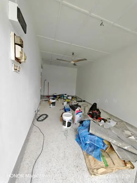 Room features: white painted walls, polished concrete flooring, ceiling fan, various paint cans, tools and equipment scattered, unfinished space, exposed electrical outlets, light fixture on ceiling.