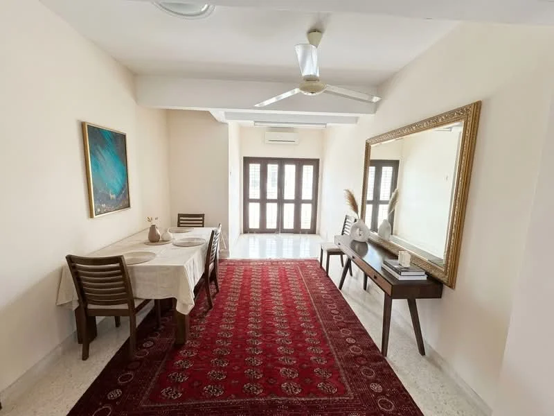 Dining features: dining table with tablecloth, 4 wooden dining chairs, area rug with intricate pattern, wall-mounted mirror with ornate frame, ceiling fan, white painted walls, large windows with wooden frames, natural light from windows, decorative artwork on wall; style: modern.