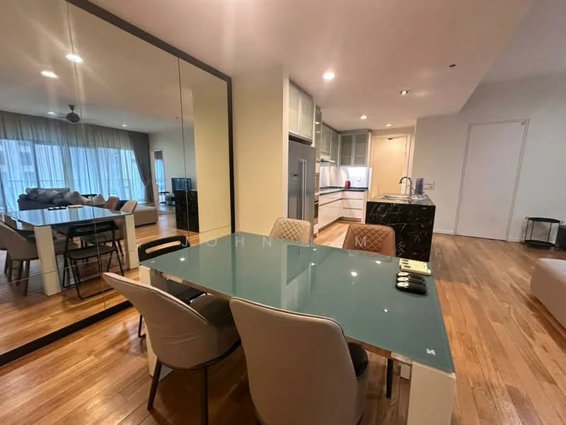 Dining features: glass dining table, upholstered dining chairs, wooden flooring, mirror wall, pendant lighting, open layout to kitchen, view of living area; style: modern. Kitchen features: kitchen island with black countertop, stainless-steel sink, built-in cabinets, recessed lighting, open layout to dining area, modern appliances, white cabinetry; style: modern. Living features: sofa, coffee table, TV console, wooden flooring, large windows with curtains, open layout to dining area, recessed lighting; style: modern.