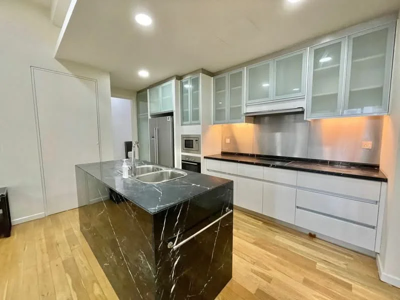Kitchen features: black marble countertop, kitchen island with sink, stainless-steel faucet, white cabinetry with glass fronts, built-in oven, stainless-steel refrigerator, black backsplash, wooden flooring, recessed downlights; style: modern.