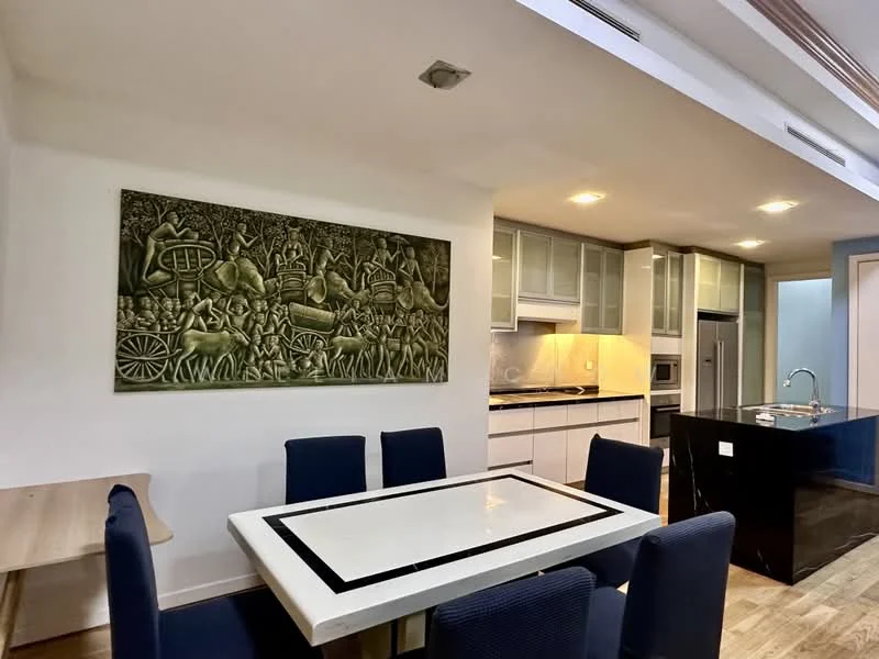 Dining features: white dining table with black trim, 6 upholstered dining chairs in navy blue, wall-mounted artwork with intricate design, wooden flooring, recessed downlights, open kitchen layout, kitchen island with black countertop, stainless-steel appliances, white cabinetry; style: modern. Kitchen features: black countertop, stainless-steel refrigerator, built-in oven, freestanding range oven, white shaker cabinets, ceramic tile backsplash, recessed downlights; style: modern.