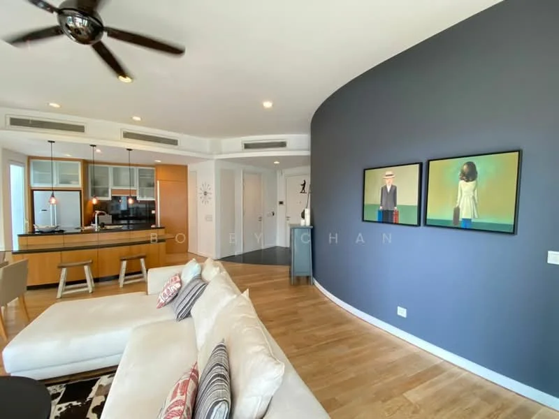 Living features: 3-seater fabric sofa in white, wooden coffee table, area rug with geometric pattern, wall-mounted TV, pendant light, ceiling fan, framed artwork, wooden flooring, grey accent wall, open-plan layout to kitchen; style: modern. Kitchen features: stainless-steel appliances, kitchen island with seating, wood cabinetry, granite countertop, recessed downlights, open shelving, glass-front upper cabinets; style: modern.