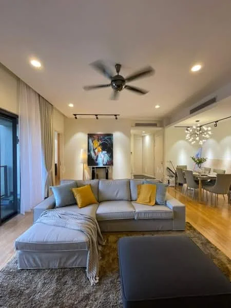 Living features: L-shape sectional sofa in light grey, yellow throw pillow, area rug with geometric pattern, ceiling fan with light, recessed LED downlights, wall-mounted artwork, floor-to-ceiling windows, sliding glass door, wooden flooring, coffee table, decorative throw blanket, TV console, dining area visible in background; style: modern; view: city.