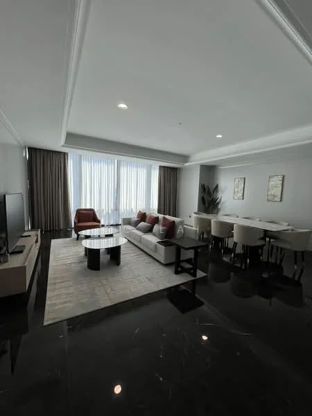 Living features: grey fabric sofa, red accent chair, black coffee table, area rug with geometric pattern, wall-mounted TV, media console, recessed ceiling lights, floor-to-ceiling windows with sheer curtains, dark marble flooring, decorative wall art, dining area with white upholstered chairs, round dining table; style: modern.