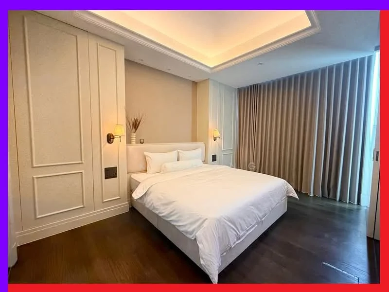 Bedroom features: king-size bed with white bedding, upholstered headboard, two wall-mounted sconces, wooden flooring, recessed ceiling lights, floor-to-ceiling windows with sheer curtains, decorative wall paneling, plush area rug; style: modern.