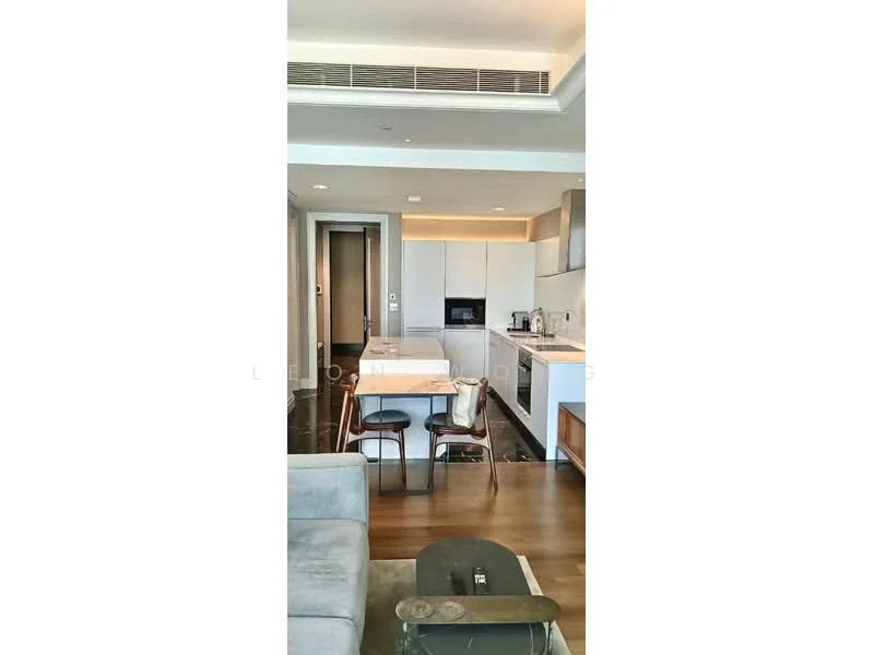 Kitchen features: white cabinetry, marble countertop, stainless-steel sink, chrome pull-down faucet, built-in oven, freestanding range oven, microwave, refrigerator, 4-burner gas hob, pendant lighting, open-plan layout, dining table with chairs, wood flooring, recessed downlights, wall-mounted air conditioning unit; style: modern. Living features: 3-seater fabric sofa, coffee table, area rug, wall-mounted TV, decorative cushions; style: modern.