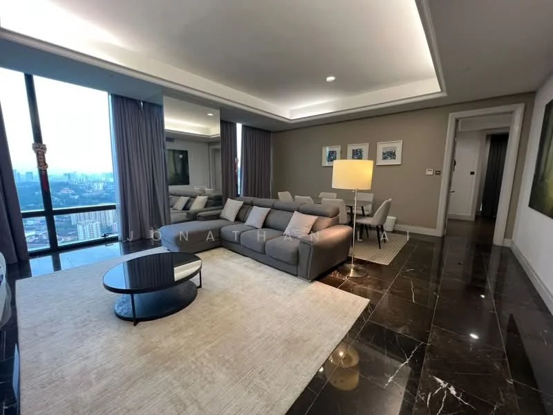 Living features: grey fabric L-shape sectional sofa, round black coffee table, area rug with neutral color, floor-to-ceiling windows, city skyline view, recessed downlights, wall-mounted artwork, light-colored walls, dark marble flooring, dining table with chairs visible in background, standing lamp; style: modern; view: city.