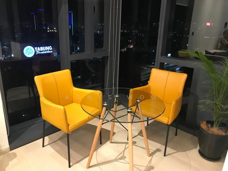 Room features: two yellow armchairs, glass round dining table, wooden legs on table, city skyline view through large windows, indoor plant in pot, modern decor, neutral tile flooring, black window frames; style: modern; view: city.