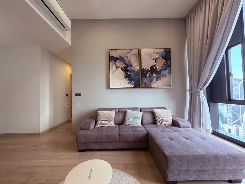 Living features: L-shape sectional sofa in grey, two decorative cushions, wooden flooring, large window with city view, curtains in light fabric, abstract artwork on wall, recessed ceiling lights, wall-mounted air conditioning unit; style: modern; view: city.