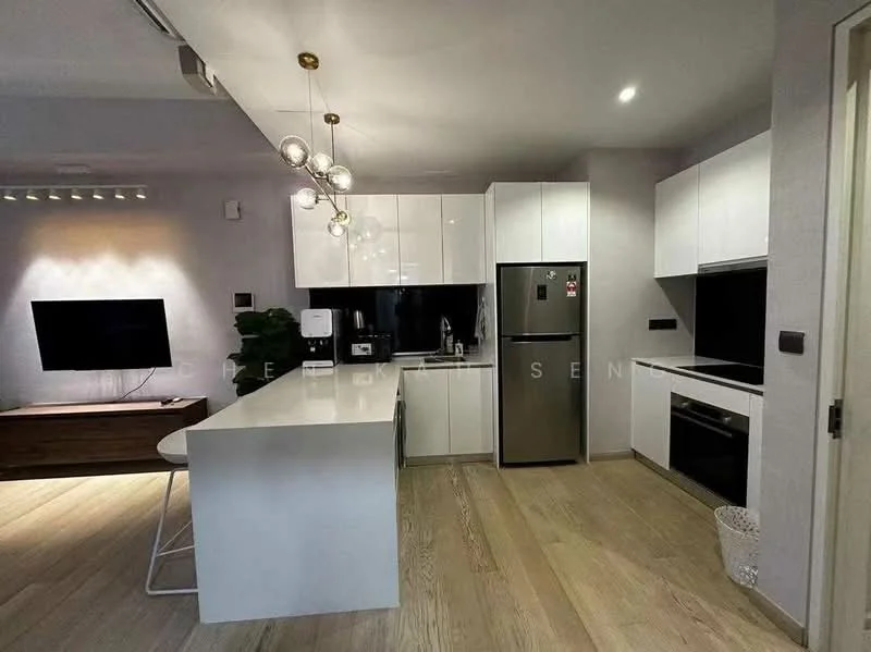Kitchen features: white cabinetry, black countertop, stainless-steel fridge, built-in oven, stainless-steel range hood, 4-burner gas hob, pendant lighting, bar seating with stools, open layout to living area, wooden flooring, black backsplash, recessed lighting; style: modern.