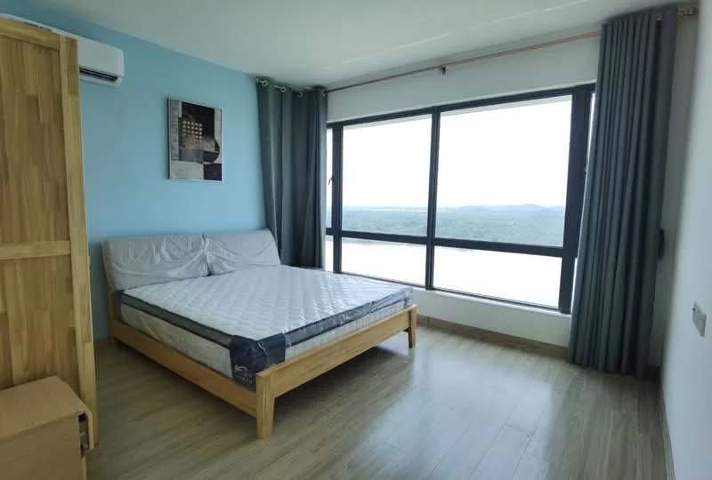 Bedroom features: queen-size bed, wooden bed frame, light blue painted walls, floor-to-ceiling windows, curtains in grey, wooden flooring, air conditioning unit, framed artwork on wall, nightstand, view of landscape; style: modern; view: landscape.