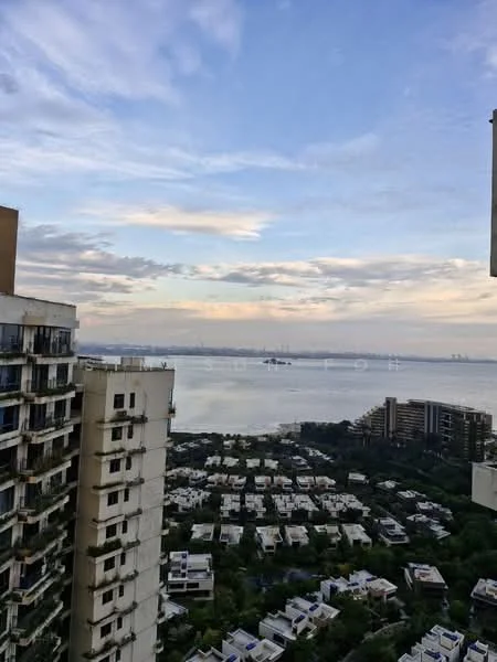 Exterior type: high-rise condominium; features: city skyline view, waterfront view, surrounding greenery, multiple low-rise buildings in foreground, cloudy sky, balconies visible on high-rise, modern architectural design; style: modern.
