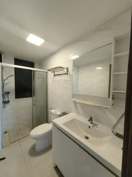 Bathroom features: white tiled walls, white ceramic floor tiles, single-sink vanity with white cabinet, chrome basin mixer faucet, framed mirror, walk-in shower with glass enclosure, toilet, towel rack, shower head, recessed ceiling light; style: modern.