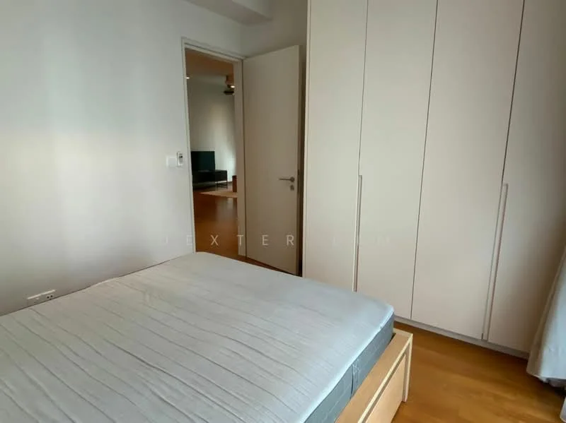 Bedroom features: queen-size bed, built-in wardrobe with sliding doors, light wood flooring, white painted walls, ceiling fan, window with sheer curtains, neutral bedding, door leading to hallway; style: modern.