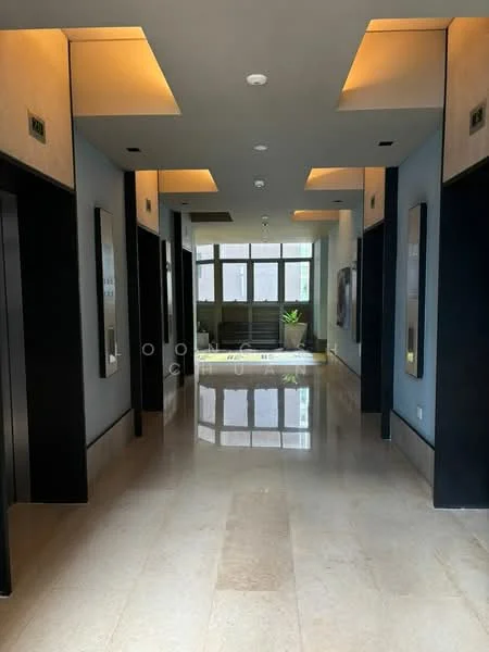 Hallway features: marble flooring, grey painted walls, recessed ceiling lights, elevators on both sides, large windows at the end, indoor plants, modern light fixtures, smooth ceiling, black accents on elevator doors; style: modern.
