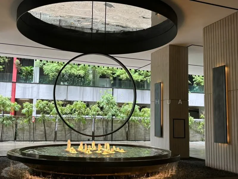 Room features: circular water feature with flames, modern chandelier, high ceiling, large circular skylight, wood paneling, stone flooring, greenery visible through windows, decorative wall panels; style: modern; view: garden.