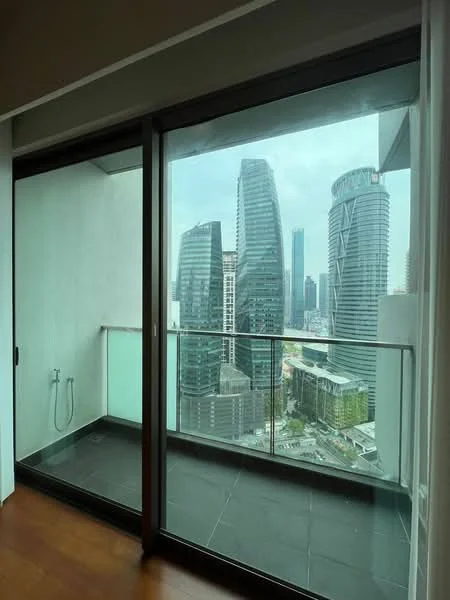 Room features: floor-to-ceiling windows, sliding glass door, balcony with glass railing, city skyline view, grey tiled flooring, exposed concrete wall, outdoor water tap; style: modern; view: city.