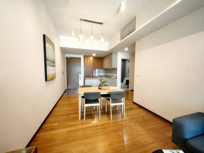 Dining features: wood flooring, white painted walls, 3-seater dining table, 4 dining chairs, pendant lighting with 3 bulbs, open layout to kitchen, decorative artwork on wall, recessed ceiling lights; style: modern. Kitchen features: kitchen island, wood cabinetry, stainless-steel appliances, open layout to dining area; style: modern.