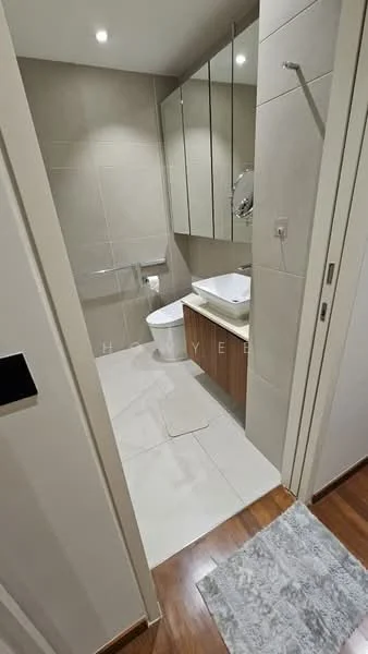 Bathroom features: white ceramic toilet, single-sink vanity with wood cabinet, mirror above vanity, chrome basin mixer faucet, shower with glass panel, tile flooring, light grey wall tiles, recessed downlights, towel rack, white countertop; style: modern.