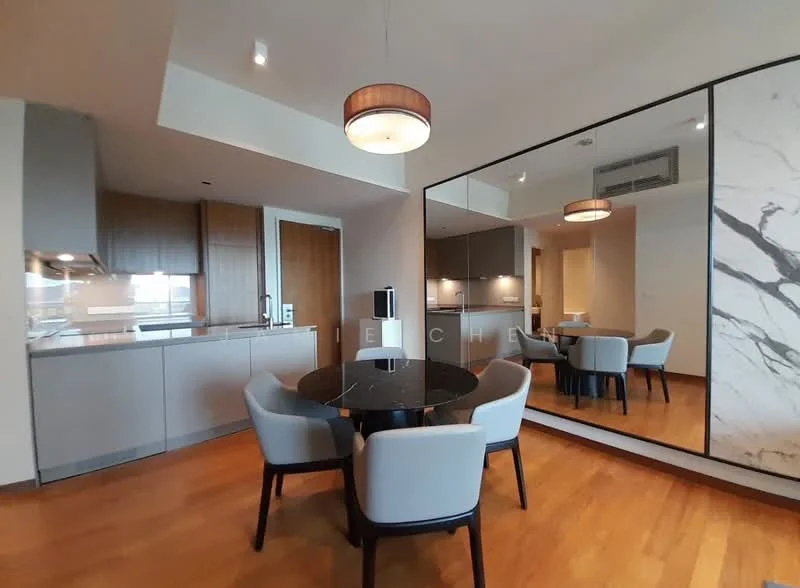Dining features: round dining table, black marble tabletop, upholstered dining chairs in light grey, wooden flooring, recessed ceiling lights, pendant light fixture, mirror wall, kitchen cabinetry with wood finish, kitchen countertop with light colour, built-in kitchen appliances; style: modern.