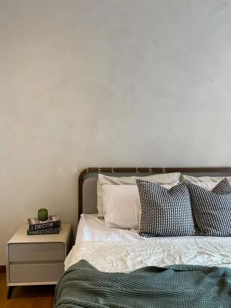 Bedroom features: queen-size bed, upholstered headboard, white bedding, black and white patterned throw pillows, nightstand, decorative book stack on nightstand, green decorative item on nightstand, textured wall, wooden flooring; style: modern.