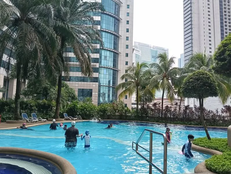 Exterior type: swimming pool deck; features: infinity pool, pool deck with loungers, tropical landscaping, palm trees, surrounded by high-rise buildings, manicured garden area; style: modern.