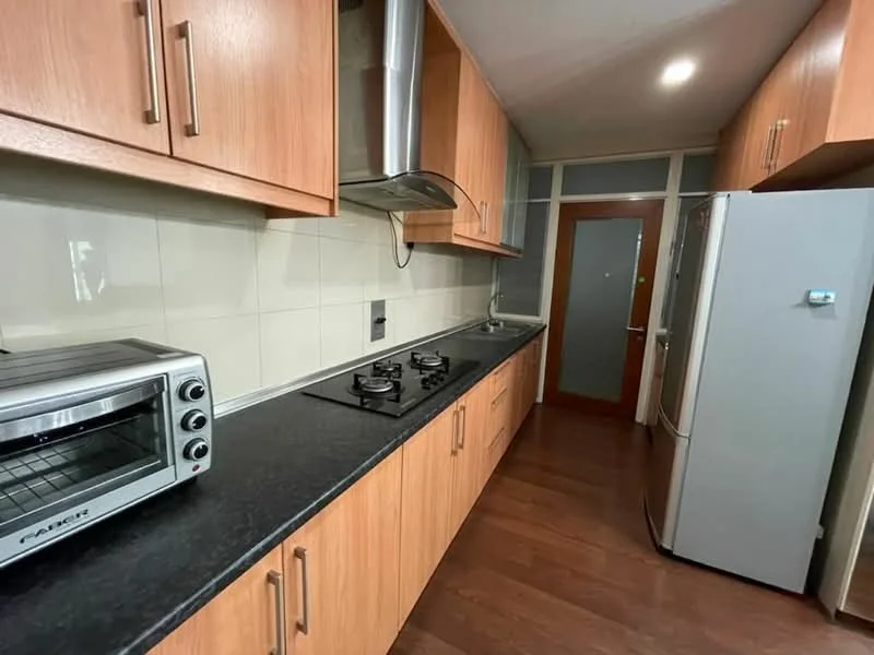 Kitchen features: wood cabinetry, black countertop, stainless-steel range hood, 4-burner gas hob, built-in oven, stainless-steel fridge, toaster oven, wall-mounted cabinet, tile backsplash, laminate flooring, recessed downlights; style: modern.