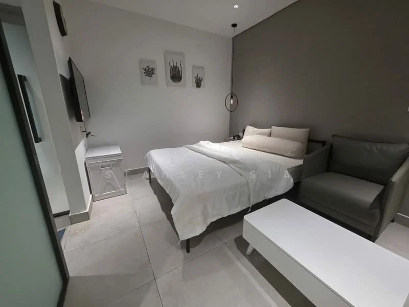 Bedroom features: queen-size bed with white bedding, upholstered headboard, bedside table in white, wall-mounted TV, grey accent wall, light-colored tiled flooring, armchair in grey, white coffee table, recessed downlights; style: modern.