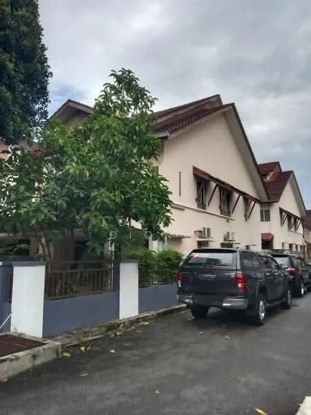 Exterior type: linked terrace house; features: two-storey building, cream painted facade, red pitched tile roof, front garden with greenery, visible air conditioning units, driveway with parking space, surrounded by mature trees, paved walkway; style: modern.