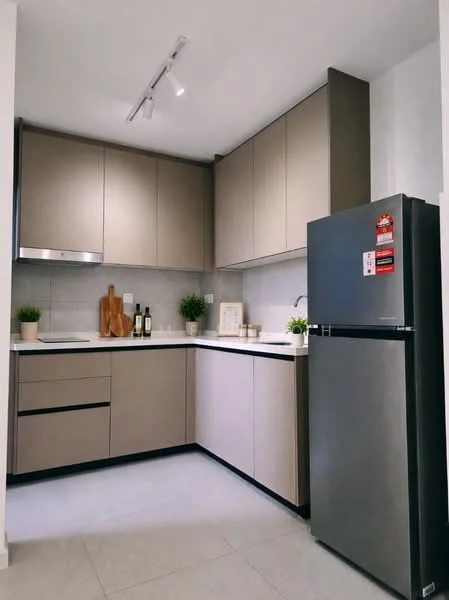 Kitchen features: L-shaped kitchen layout, light grey cabinetry, white countertop, stainless-steel sink, chrome pull-down faucet, built-in oven, freestanding fridge in stainless steel, track lighting, decorative wooden cutting board, two potted plants, grey tile backsplash, ceramic tile flooring; style: modern.