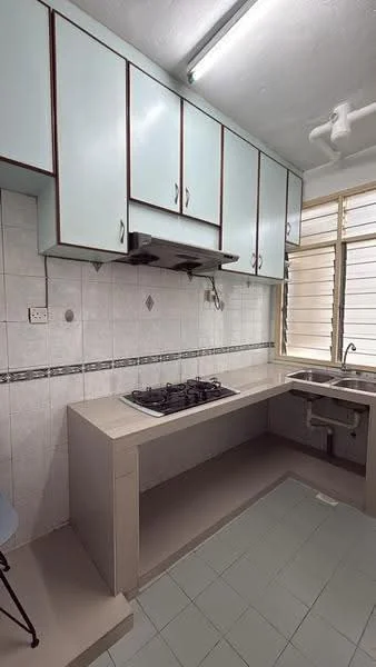Kitchen features: light blue cabinetry with wood trim, white tiled walls, grey countertop, 4-burner gas hob, stainless-steel range hood, single-bowl stainless-steel sink, window with horizontal slats, tile flooring in light green, wall-mounted light fixture, built-in cabinetry, decorative tile border; style: modern.