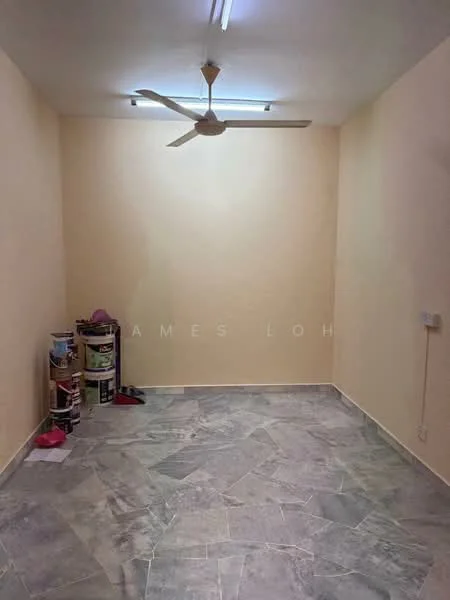 Room features: light grey marble flooring, cream painted walls, ceiling fan, fluorescent ceiling lights, power outlet on wall, small storage area with paint cans.