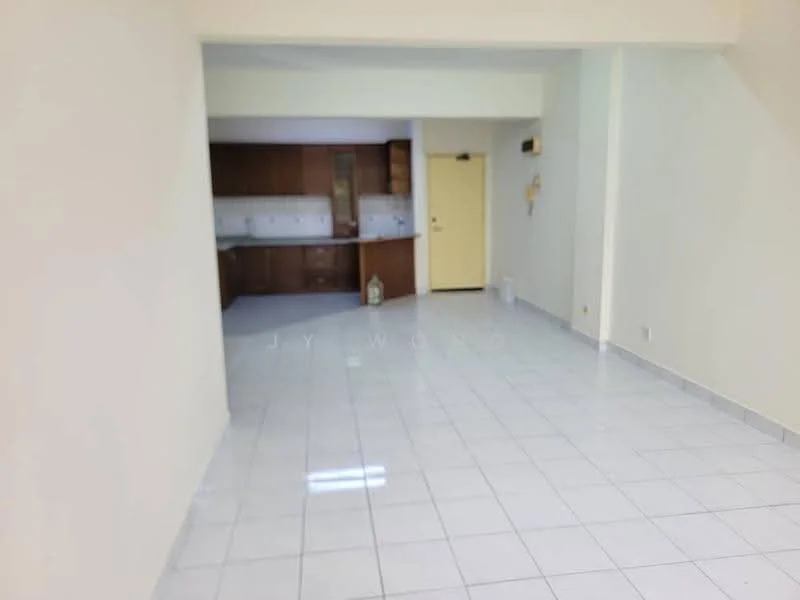 Room features: white painted walls, glossy white tile flooring, kitchen area visible in background, wood cabinetry in kitchen, single door leading to another room, light-colored ceiling, no visible furniture, open layout.