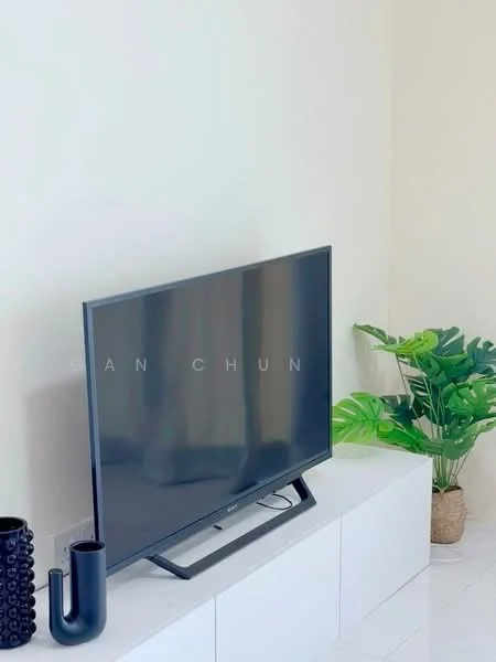 Room features: flat-screen TV, white TV console, decorative black vase, decorative black pipe-shaped object, green potted plant, light-colored walls, glossy floor tiles; style: modern.