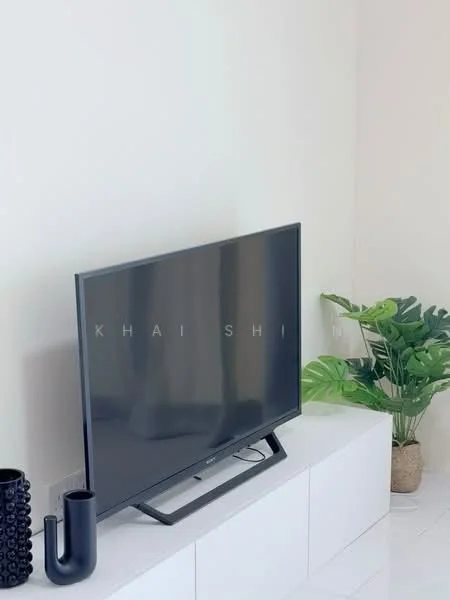 Living features: flat-screen TV on console, white media console, decorative plant in pot, black decorative vase, minimalist decor, light-colored walls, glossy tile flooring; style: modern.