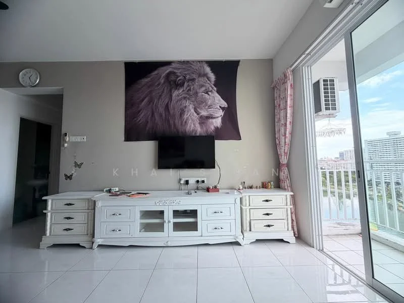 Living features: white tiled flooring, light grey painted walls, large wall-mounted TV, white TV console with drawers, decorative wall art featuring a lion, floor-to-ceiling sliding glass door, curtains with floral pattern, wall clock, wall-mounted air conditioning unit; style: modern; view: city.