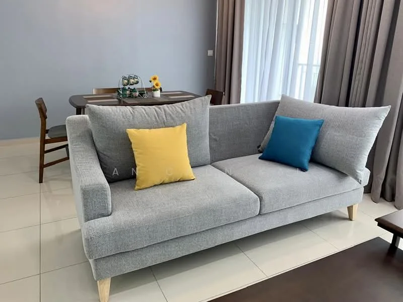 Living features: grey fabric sofa with wooden legs, yellow throw pillow, blue throw pillow, white walls, light grey curtains, dining table in background, wooden dining chairs, tile flooring, natural light from large windows; style: modern.