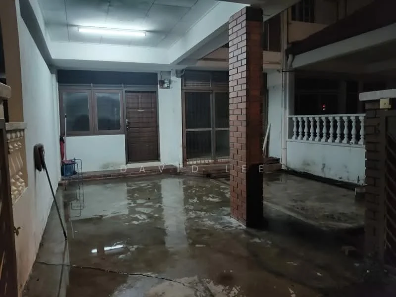 Room features: polished concrete flooring, exposed brick columns, white painted walls, ceiling with fluorescent lighting, large windows, double wooden doors, balustrade with decorative railing.